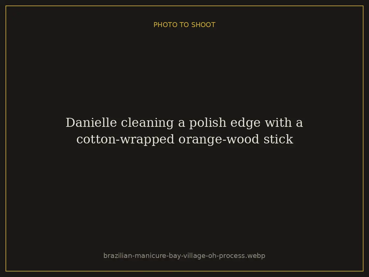 Danielle cleaning a polish edge with a cotton-wrapped orange-wood stick at Brazilian Nails By Danielle in Westlake, Ohio, a short drive from Bay Village